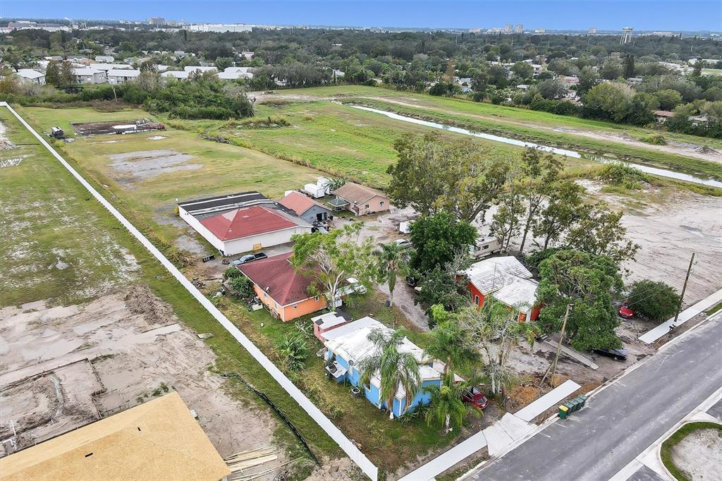 An aerial view shows several small houses and a commercial building on a large lot — 1616 23RD STREET E, BRADENTON, FL