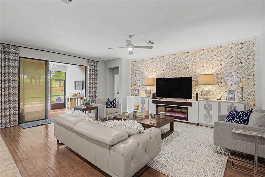 A dining area with a dark wicker table set sits beside an entryway with tile — 4926 SOUTHERN VALLEY LOOP, BROOKSVILLE, FL