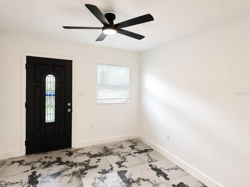 An interior room features a black front door, a ceiling fan, and patterned floor tiles — 606 EL VEDADO AVENUE, ORLANDO, FL