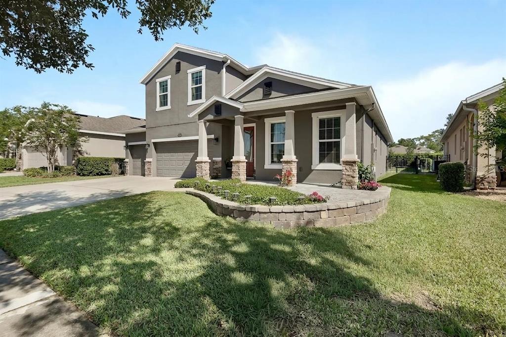 An aerial view shows a suburban neighborhood with houses, a pond, and a blue star — 337 ORCHARD HILL STREET, DELAND, FL