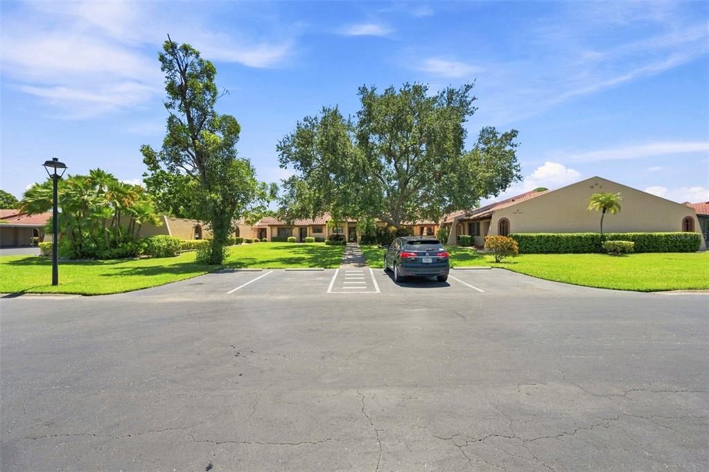 A gray SUV is parked in a lot in front of a single-story residential building — 9683 86TH AVENUE, SEMINOLE, FL
