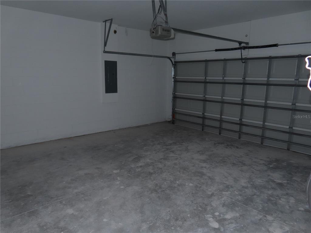 A bedroom with a queen bed, two nightstands, a window with curtains, and wood flooring — 4517 AMERICA STREET, ORLANDO, FL