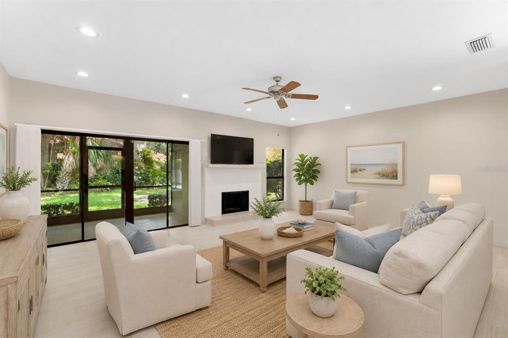 A brick walkway leads to the front entrance of a house with a tile roof — 4820 KESTRAL PARK CIRCLE UNIT 18, SARASOTA, FL