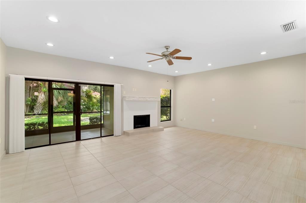 A paved walkway leads to the front entrance of a house with a red-tiled roof — 4820 KESTRAL PARK CIRCLE UNIT 18, SARASOTA, FL