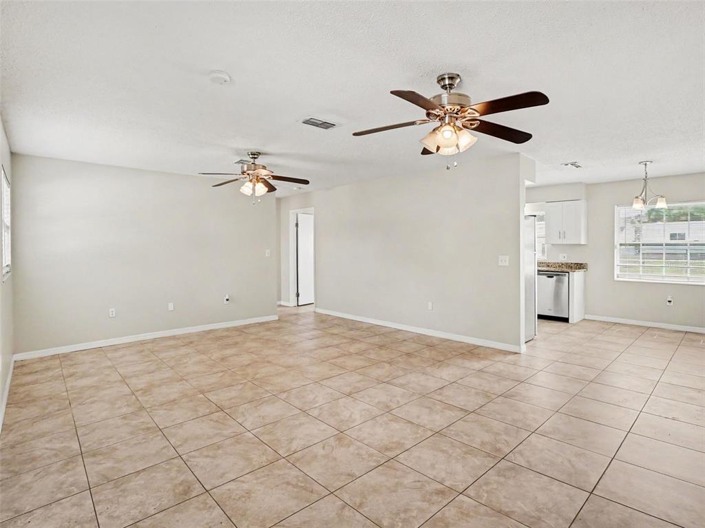 A kitchen with white cabinets, stainless steel appliances, and granite countertops — 3255 KELVINGTON DRIVE, ORLANDO, FL