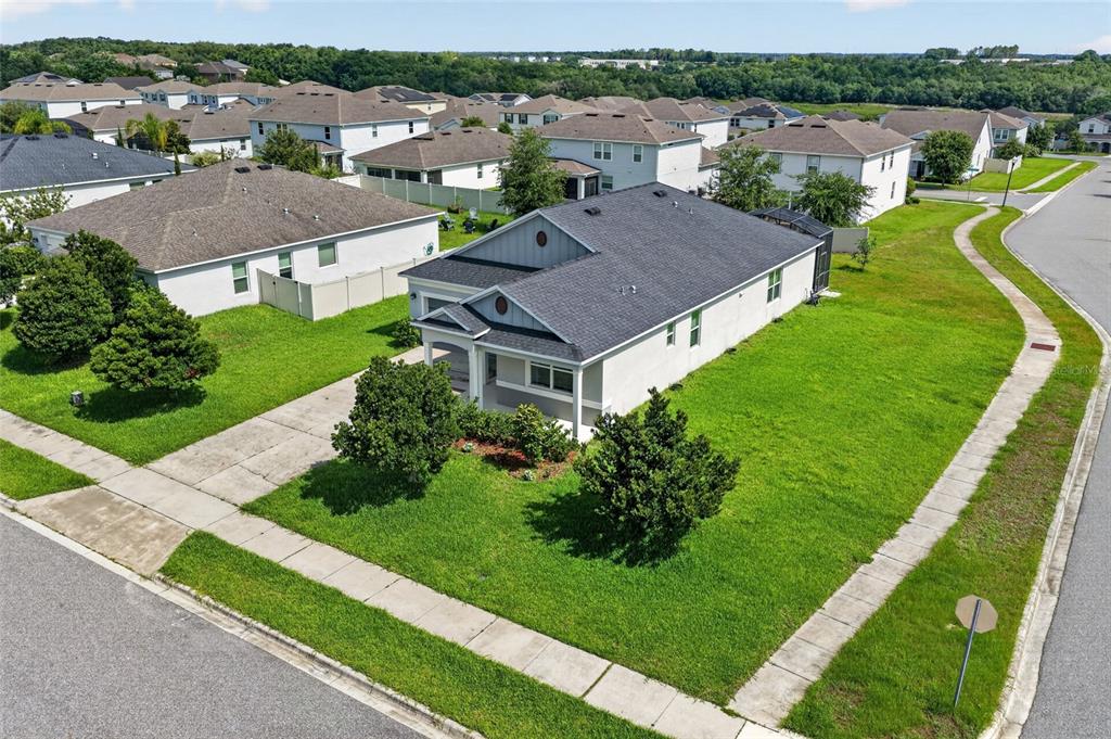 An aerial view shows a single-story suburban house with a gray roof and driveway — 2364 CARRIAGE POINTE LOOP, APOPKA, FL