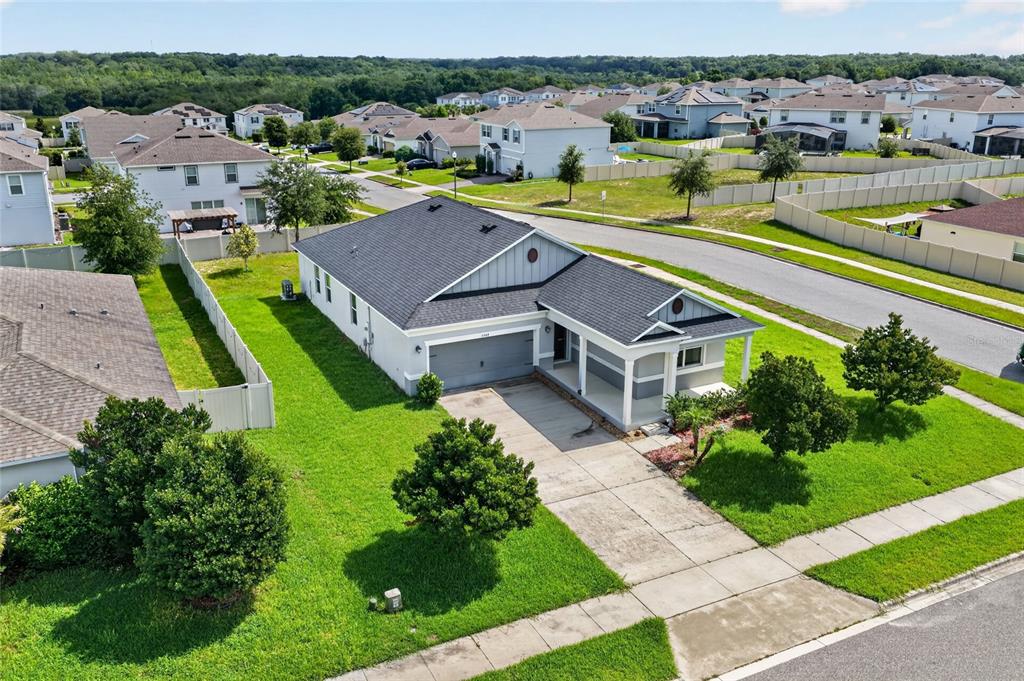 An aerial view of a suburban house with a gray roof and a concrete driveway — 2364 CARRIAGE POINTE LOOP, APOPKA, FL