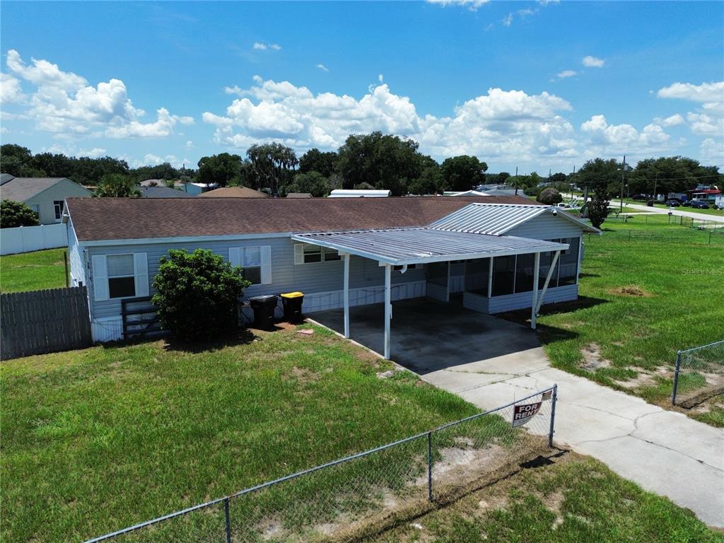 A light gray mobile home with a screened-in porch and a satellite dish on the roof — 4300 MEADOW RIDGE AVENUE, MULBERRY, FL