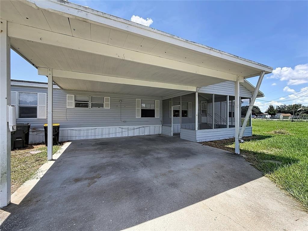 An aerial view of a single-story house with a carport, screened porch, and chain-link fence — 4300 MEADOW RIDGE AVENUE, MULBERRY, FL