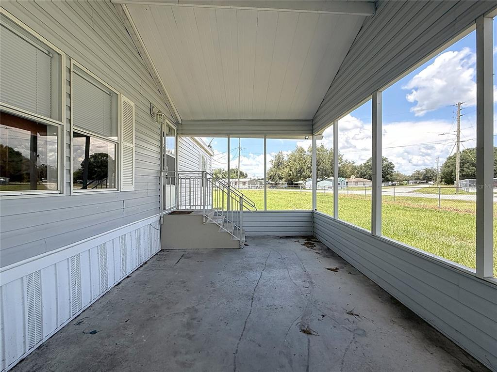 An aerial view of a single-story manufactured home with a carport and a fenced yard — 4300 MEADOW RIDGE AVENUE, MULBERRY, FL