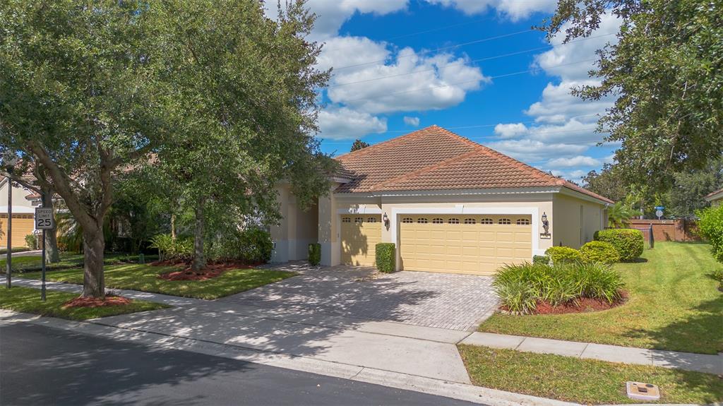 A single-story house with a tiled roof, a two-car garage, and a paved driveway — 524 DOUGLAS EDWARD DRIVE, OCOEE, FL