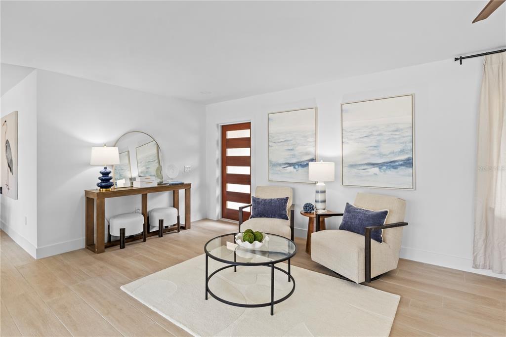 A single-story house with a white exterior, dark metal roof, and a paved driveway — 624 DUNDEE LANE, HOLMES BEACH, FL