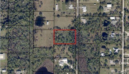 This aerial map shows a rectangular plot of land outlined in red near a road — MCCAIN LN, MALABAR, FL
