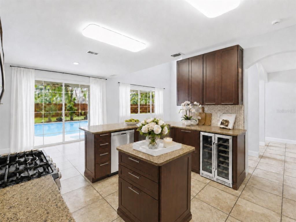A two-story house with a beige stucco exterior, a two-car garage, and a front lawn — 1610 LEDGESTONE DRIVE, BRANDON, FL