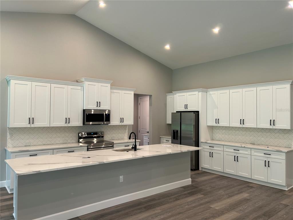 A single-story house with a gray exterior, a two-car garage, and a covered front porch — 14 STATICE COURT, HOMOSASSA, FL