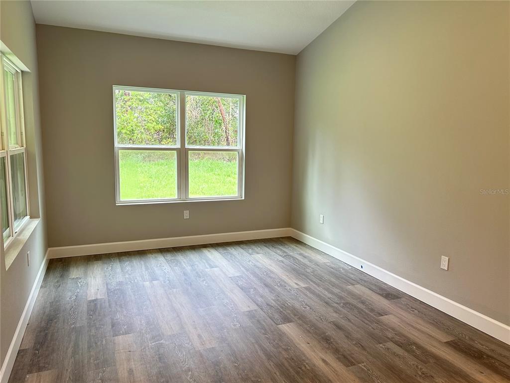A living room features a sofa, coffee table, wooden sideboard, and a view of water — 14 STATICE COURT, HOMOSASSA, FL