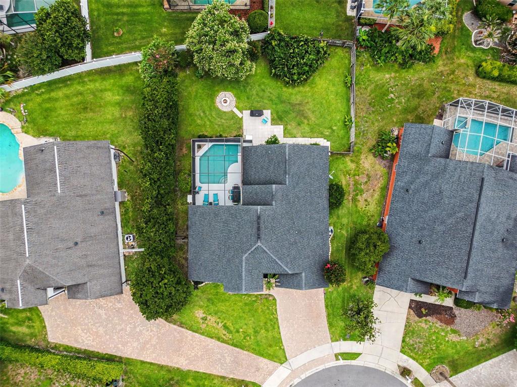 A single-story teal house with a white garage, arched entryway, and a front lawn — 1986 CRYSTAL DOWNS COURT, OVIEDO, FL