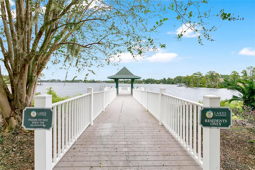 A wooden pier with white railings leads to a gazebo overlooking a lake — 6712 THORNHILL CIRCLE, WINDERMERE, FL