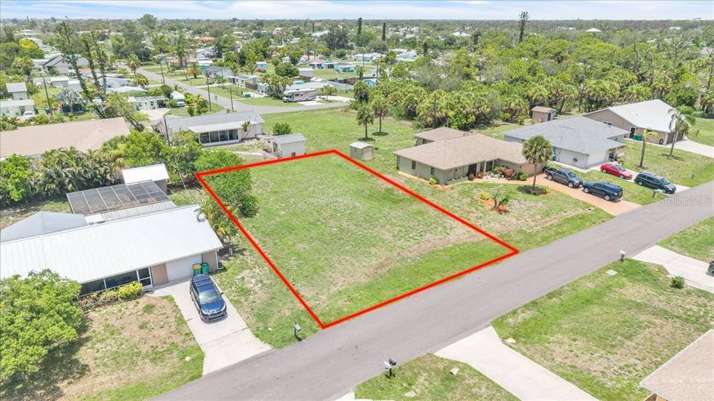 An aerial view shows a vacant rectangular lot outlined in red between two residential houses — 1274 CORAL LANE, ENGLEWOOD, FL