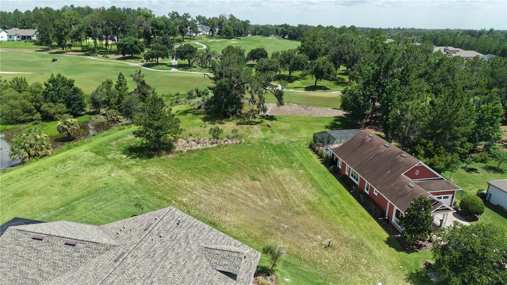 A vacant, grassy residential lot features a real estate sign in the center — 19492 FOREST GARDEN COURT, BROOKSVILLE, FL