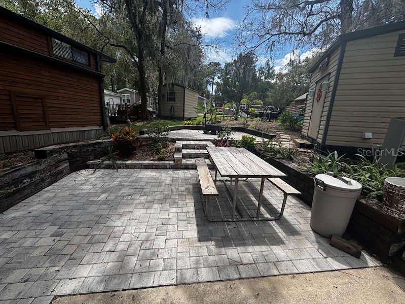 Outdoor stone steps feature decorative tile risers and colorful lizard accents on the side walls — 25244 NE 143RD  ST UNIT 180, SALT SPRINGS, FL