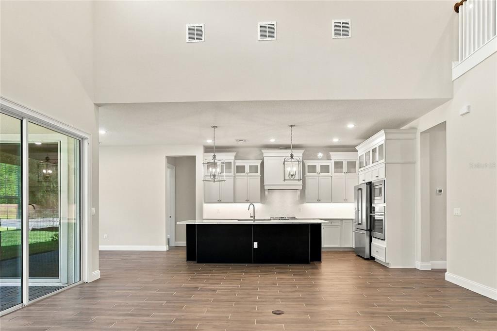 This rendering shows a bright living room with white walls, a lofted balcony, and blue accents — 424 MARINA LOUIS POINT, SANFORD, FL