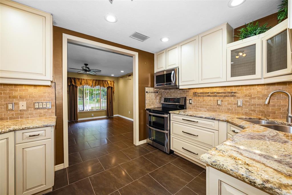 A front entryway features a white-sided exterior, a storm door, a mailbox, and a planter — 6701 ORCHARD DRIVE N, ST PETERSBURG, FL