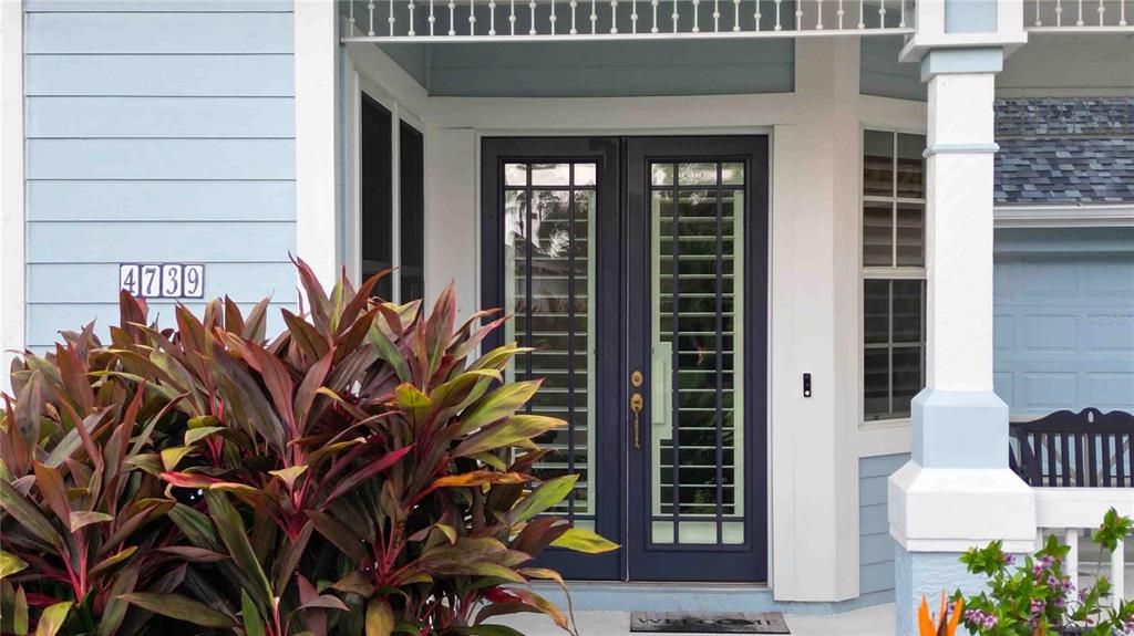 A front porch features a dark blue double door with glass panes and house number 4739 — 4739 PINNACLE DRIVE, BRADENTON, FL