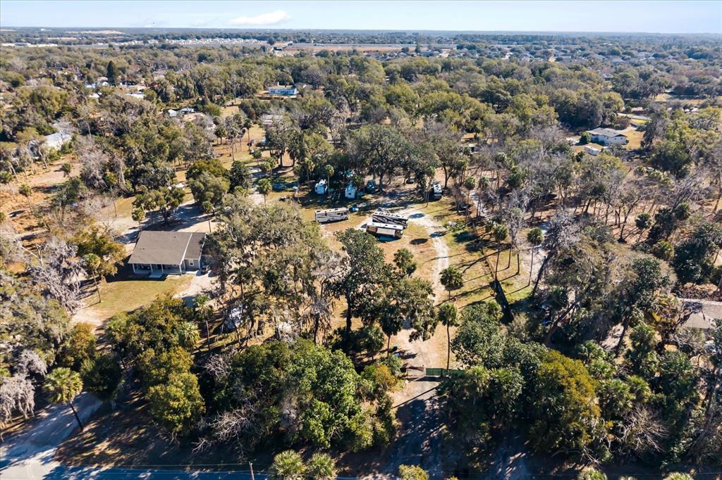 An aerial view shows a house and several RVs on a wooded, rural lot — WALKER ROAD, APOPKA, FL