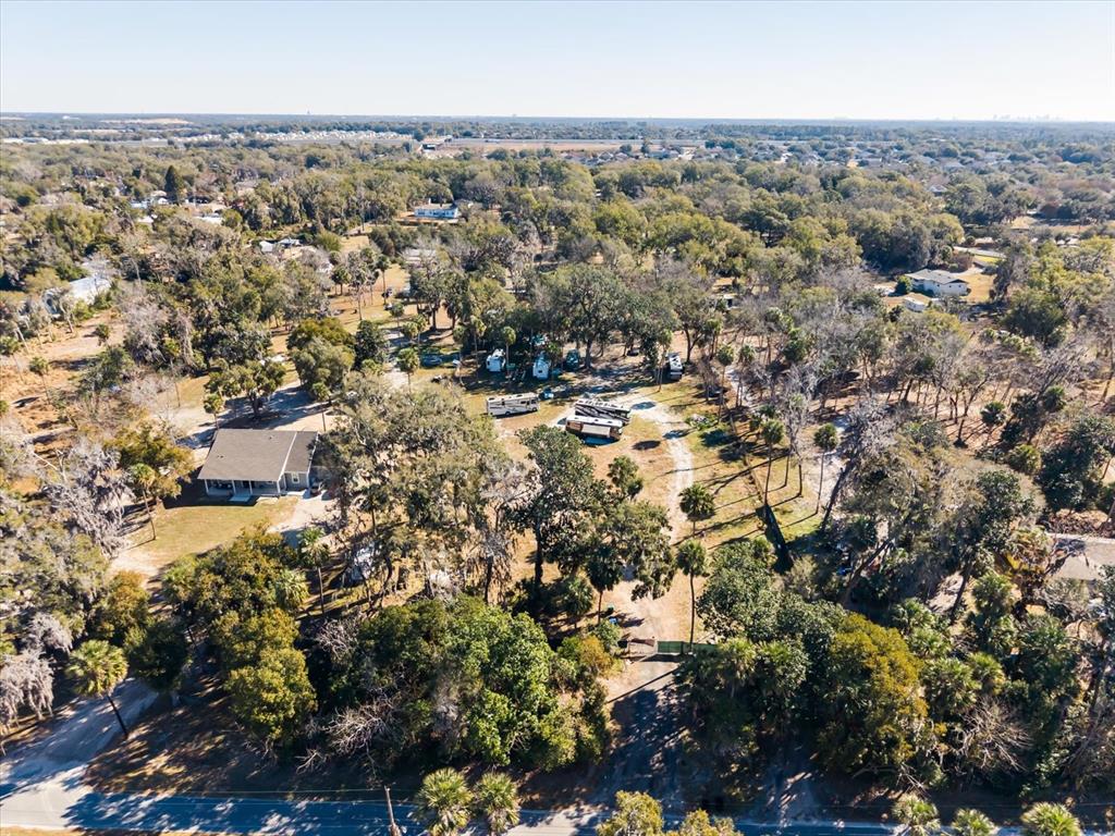 An aerial view shows a wooded property with a house, several RVs, and a driveway — WALKER ROAD, APOPKA, FL