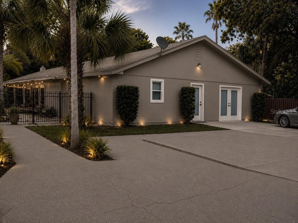 A single-story house with a gray exterior, a concrete driveway, and a fenced-in porch area — 4327 PLYMOUTH SORRENTO ROAD, APOPKA, FL