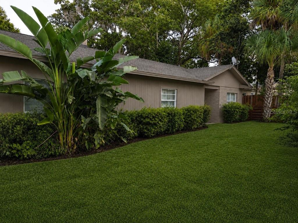 A single-story house with tan siding, a shingled roof, and a manicured lawn — 4327 PLYMOUTH SORRENTO ROAD, APOPKA, FL