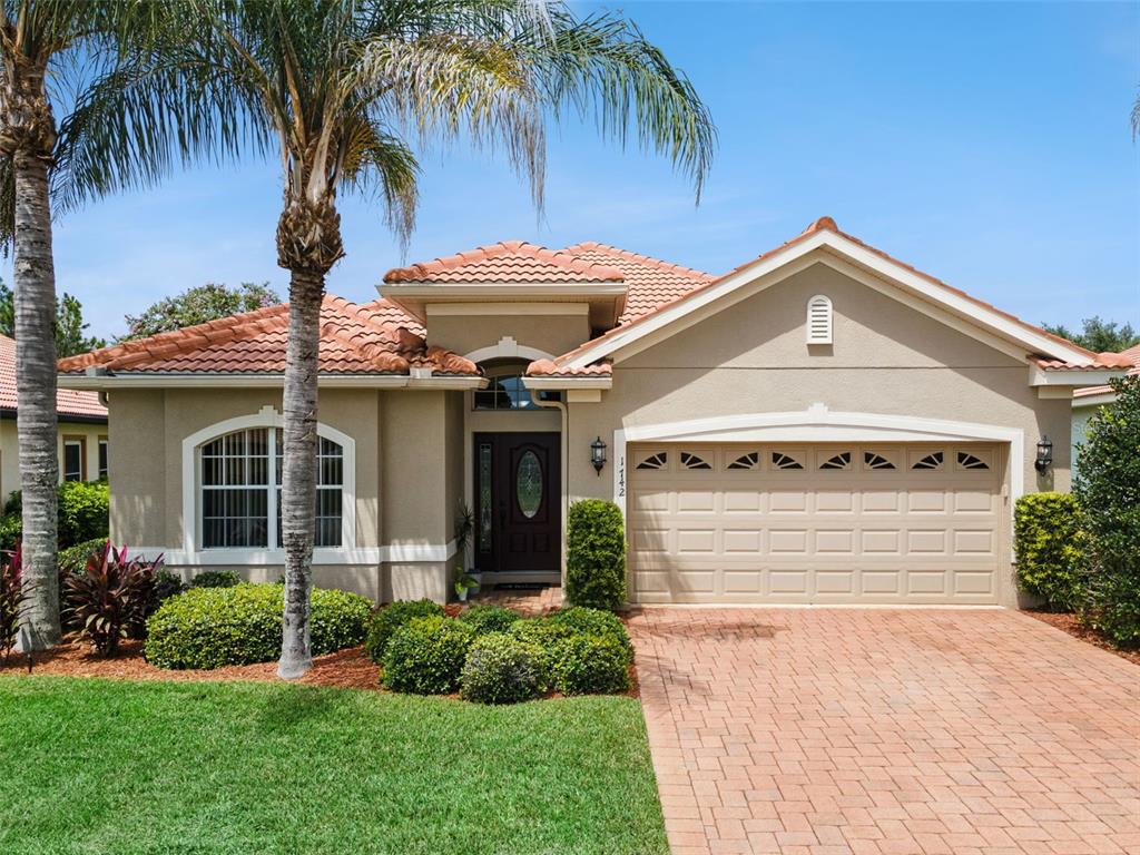 A living room features tile floors, a fireplace console, a ceiling fan, and an entryway door — 1742 ALTAVISTA CIRCLE CIRCLE, LAKELAND, FL