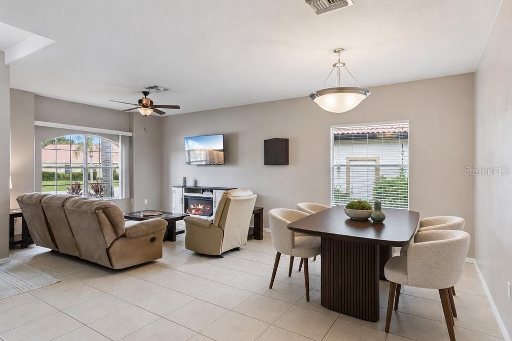 A living room features a foosball table, beige tile flooring, and a ceiling fan — 1742 ALTAVISTA CIRCLE CIRCLE, LAKELAND, FL