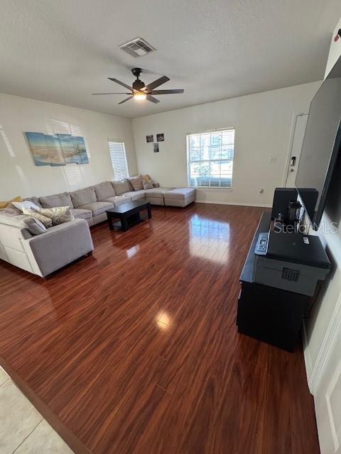 A living room features a large sectional sofa, hardwood flooring, and a ceiling fan — 4632 CHATTERTON WAY, RIVERVIEW, FL