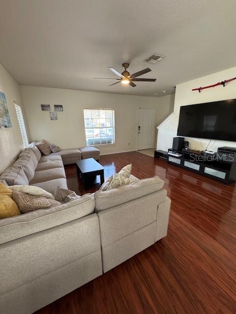 A living room features a large sectional sofa, hardwood floors, and a wall-mounted television — 4632 CHATTERTON WAY, RIVERVIEW, FL
