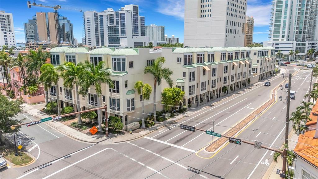 An aerial view of a multi-story residential complex situated at a street intersection — 235 COCOANUT AVENUE UNIT 108B, SARASOTA, FL