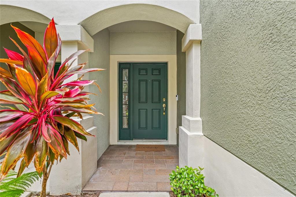 A teal front door with a side window is set within a covered entryway — 4879 POND RIDGE DRIVE, RIVERVIEW, FL