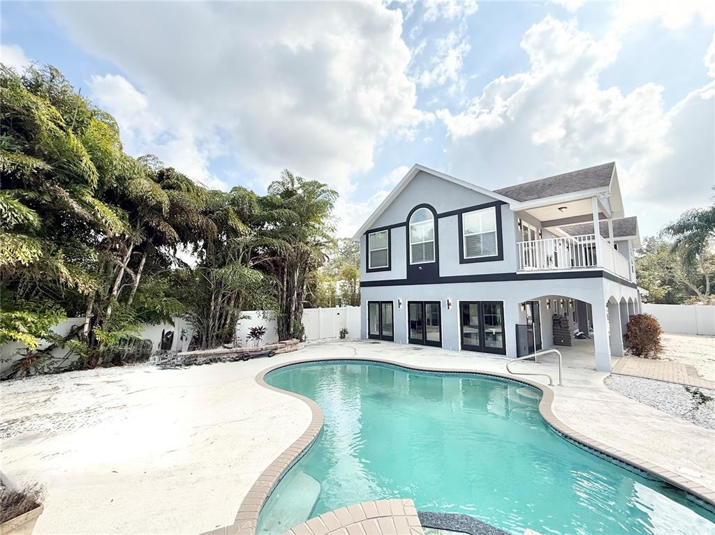 A two-story house with a swimming pool and palm trees in the backyard — 6710 MYRNA DRIVE, TAMPA, FL