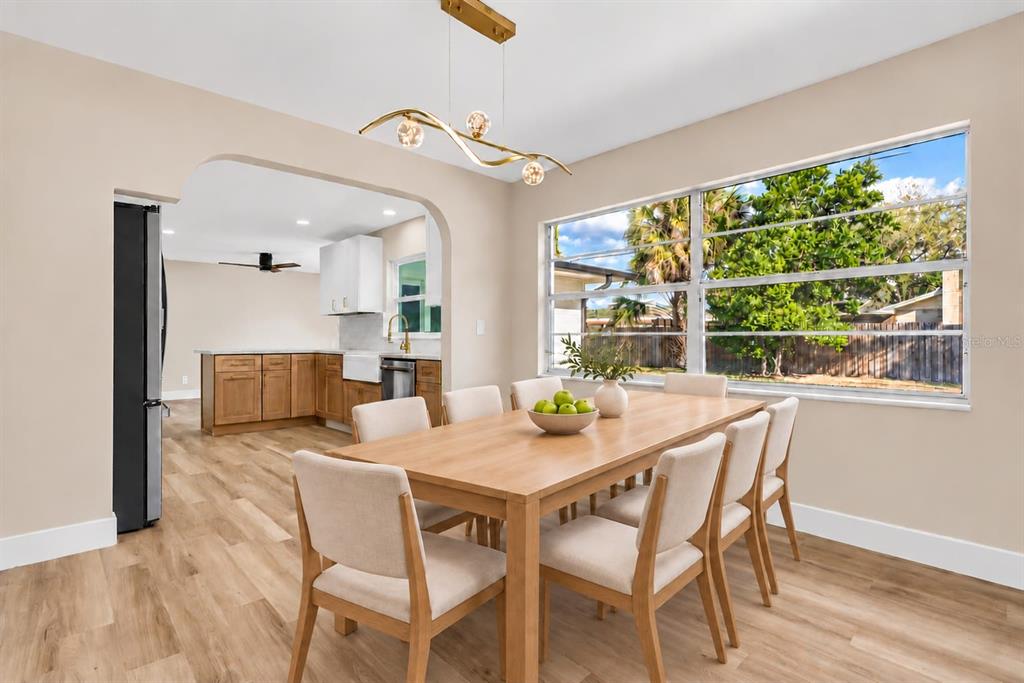 A single-story house with a white exterior, stone facade, and a paved driveway — 330 ELKHORN COURT, WINTER PARK, FL