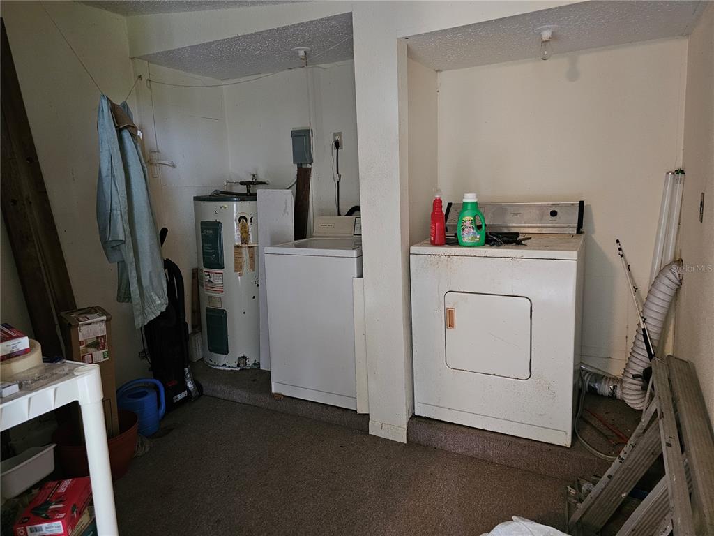 A utility room contains a water heater, a washing machine, and a clothes dryer — 320 COUNTY ROAD 619, LAKE PLACID, FL