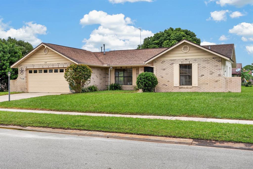 A single-story brick house with a two-car garage and a large front lawn — 104 COLLEEN DRIVE, DAYTONA BEACH, FL