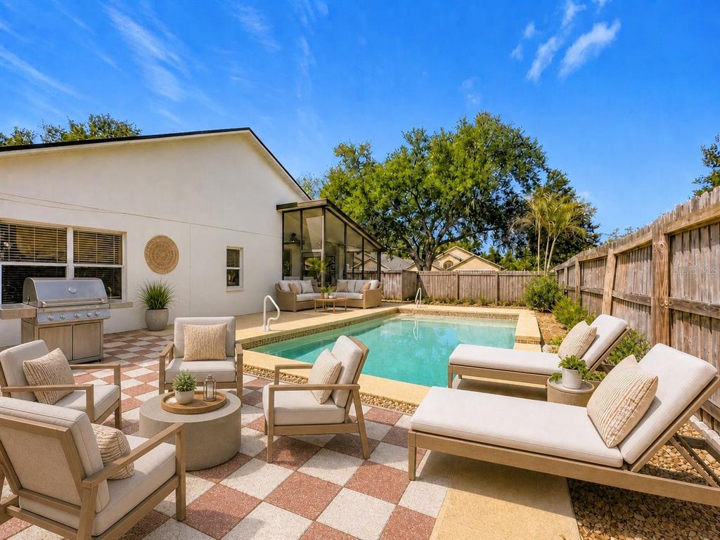 A backyard patio features a swimming pool, lounge chairs, a grill, and a glass-enclosed sunroom — 7116 COLONY POINTE DRIVE, RIVERVIEW, FL