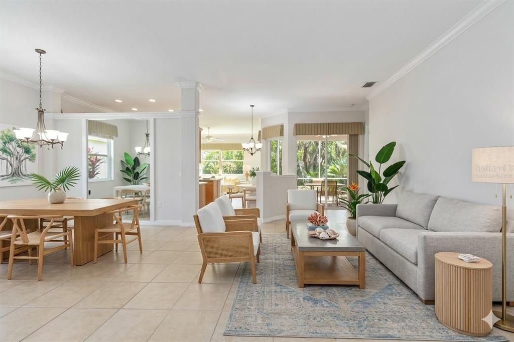 A single-story house with a beige stucco exterior, a two-car garage, and a paved driveway — 8150 INDIGO RIDGE TERRACE, UNIVERSITY PARK, FL