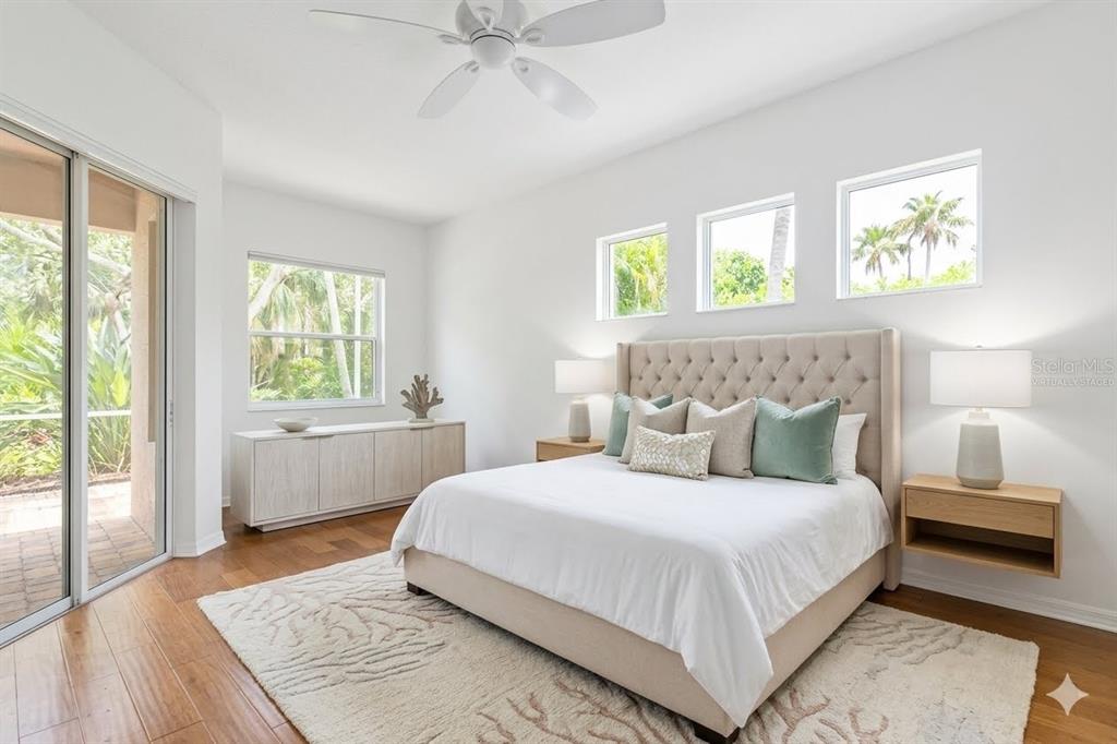 A living room features a sectional sofa, a wooden coffee table, and coastal-themed wall art — 8150 INDIGO RIDGE TERRACE, UNIVERSITY PARK, FL