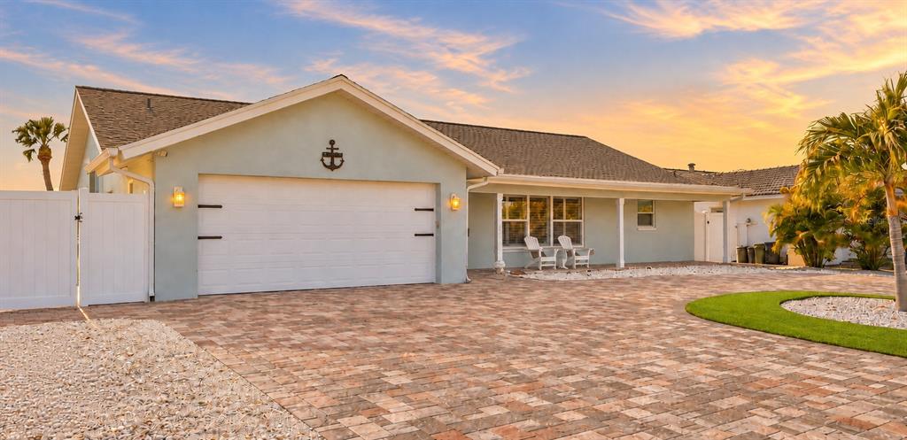 A view of a calm waterway with houses and docks along the distant shoreline — 6420 3RD PALM POINT, ST PETE BEACH, FL