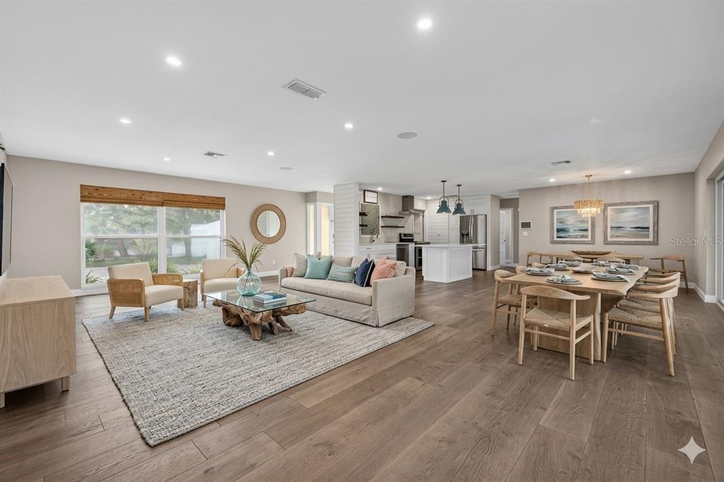 A single-story house with a white stone facade, a teal front door, and a driveway — 4200 BEACH DRIVE SE, ST PETERSBURG, FL