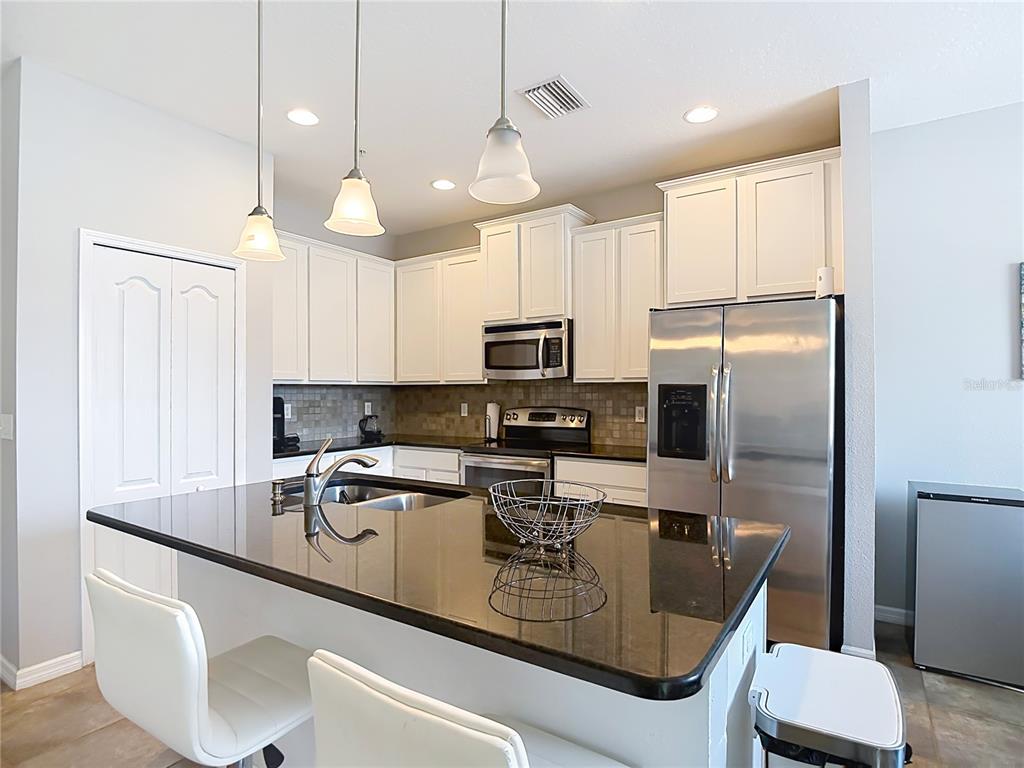 An aerial view of a multi-story apartment complex with a swimming pool and parking lot — 8615 ANDALUCIA FIELD DRIVE, TAMPA, FL