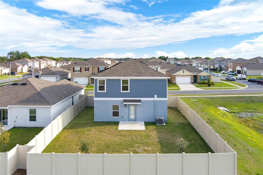 An aerial view of the rear exterior of a two-story house with a fenced yard — 271 INMAN BOULEVARD, WINTER HAVEN, FL