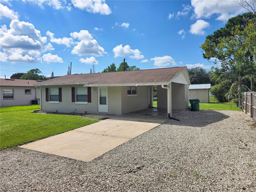 A single-story house features a tan exterior, a brown shingled roof, and an attached carport — 185 E LAKE MARY AVENUE, LAKE MARY, FL